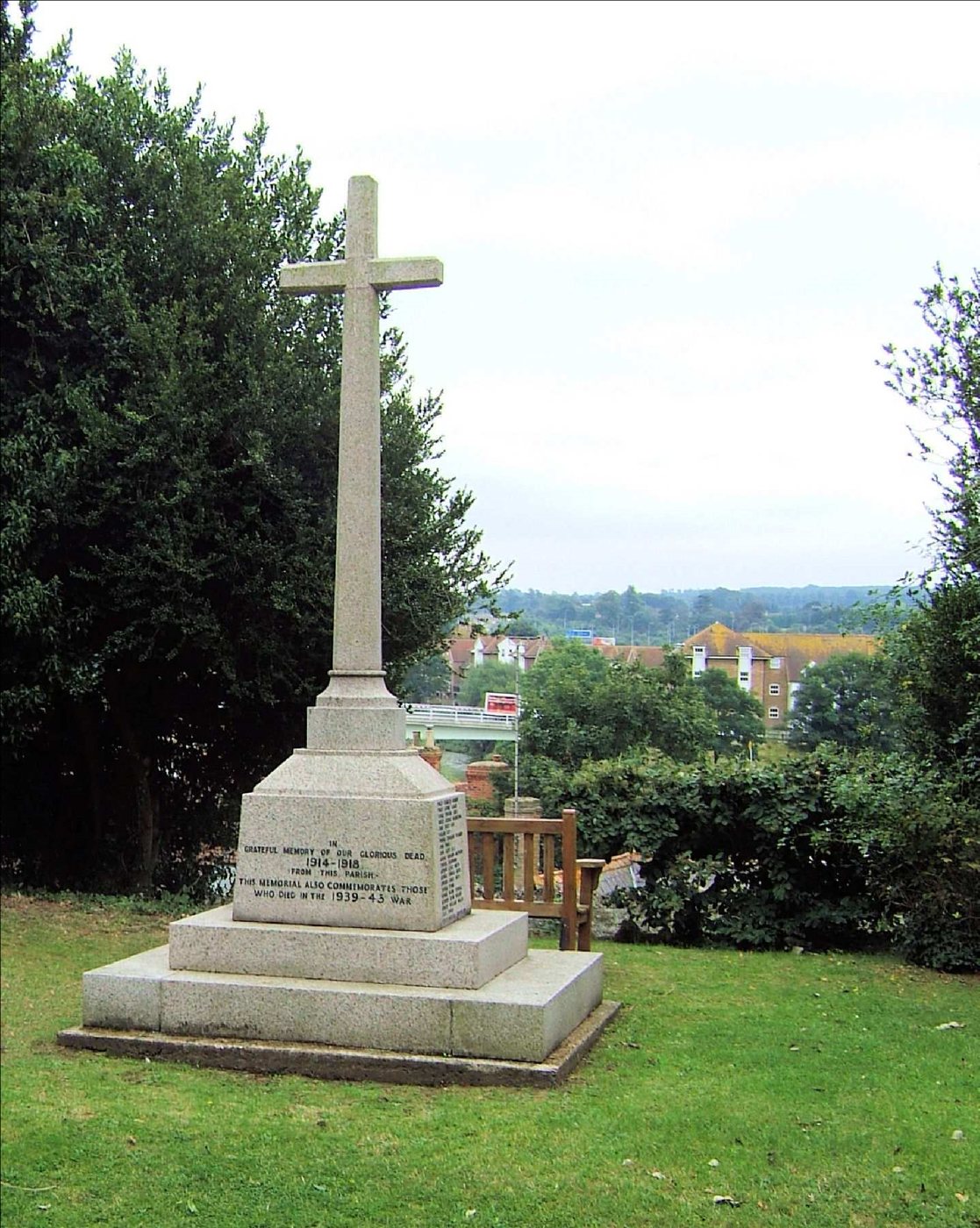 Granite cross on a stepped base in Aylesford churchyard, with the Medway valley beyond
